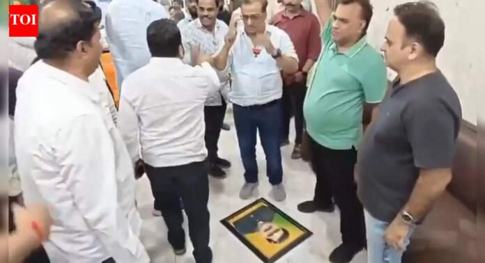 BJP issues show-cause notice to party worker after photo of former corporator who left party was blackened | Thane News