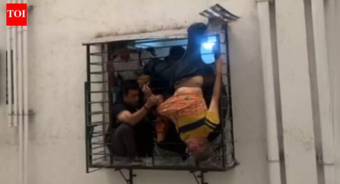 Christmas Day miracle in Surat: Man slips from 10th floor, gets stuck on 8th floor window grill; heart-stopping visuals emerge | Surat News